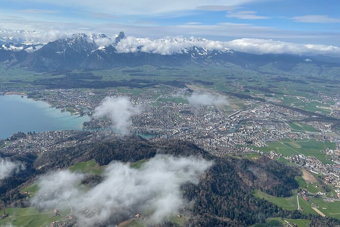 Helicopter tour to the Stockhorn mountain, with great view to the Swiss Alps - Belp Berg and the farm look: cows and grain from the air