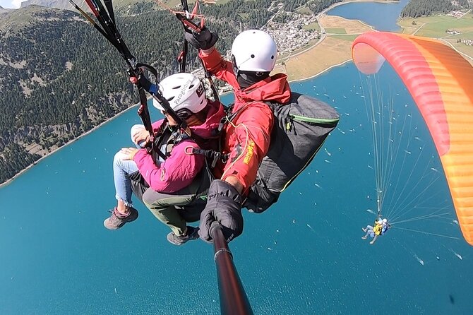 Paragliding Tandem Flights in Engadin - Safety briefing and tandem flying with pilots like Davide, Matt, and Peter