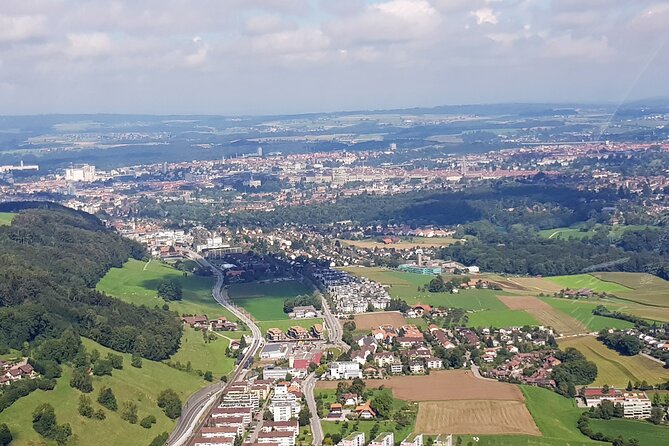 Swiss Capital city helicopter sightseeing tour - the ideal flight to see Berne - Stadium, solar collectors, and the YB logo from the cockpit